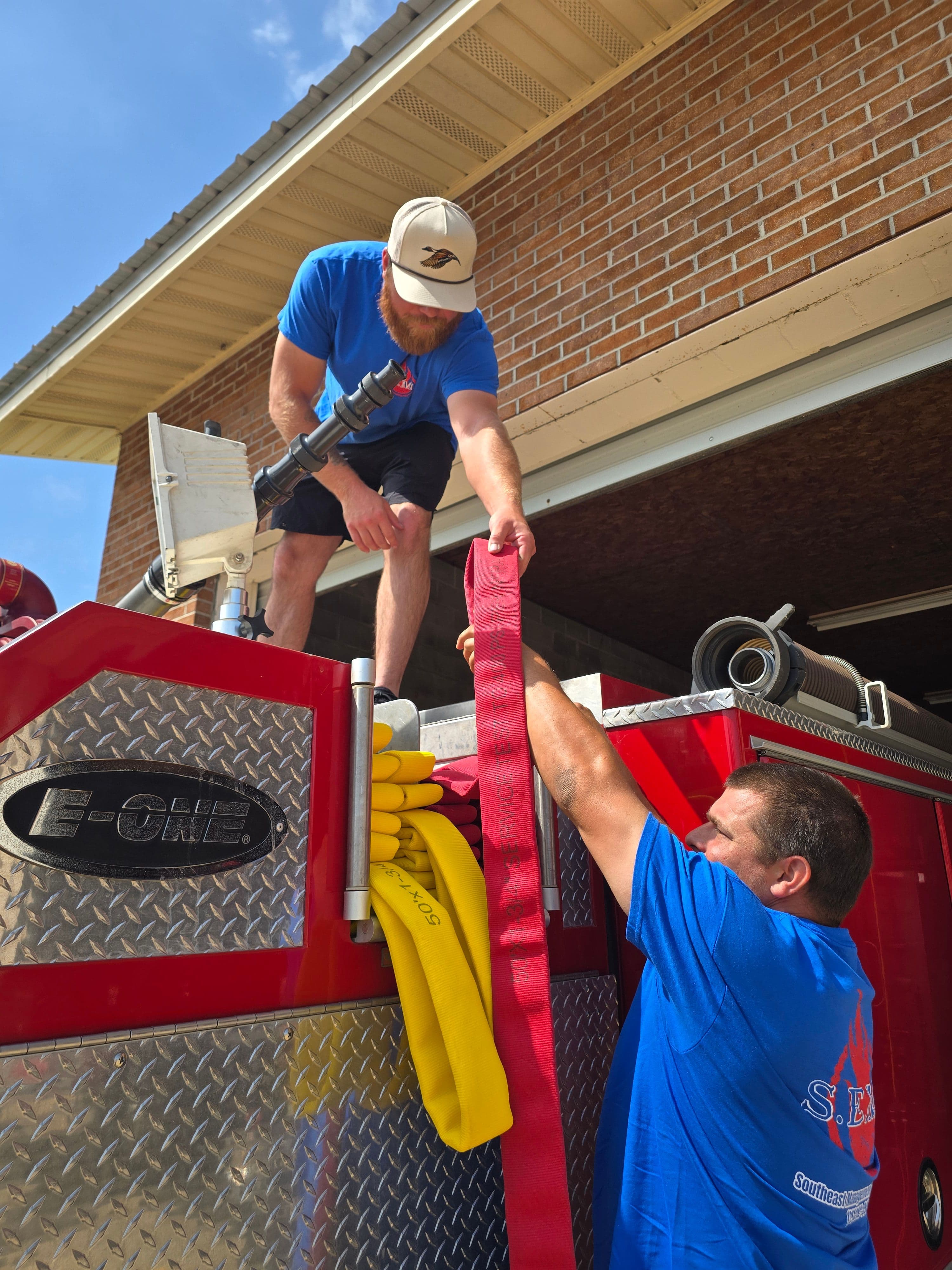 SEMS technicians reloading tested fire hose onto the apparatus hose bed